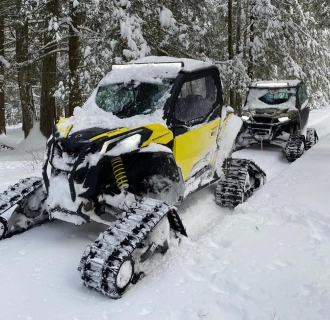 Two UTV vehicles in the snow